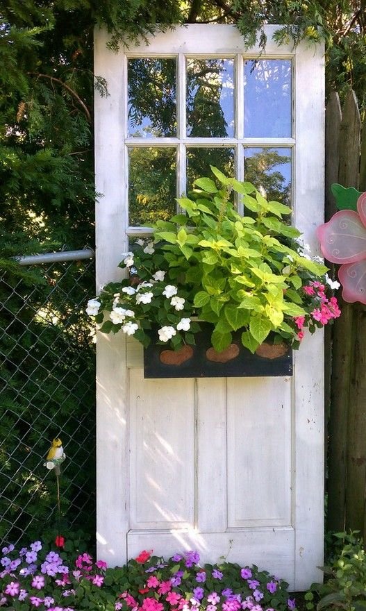Create this garden spot with an old window door and an attached container of flowers!...old screen door also...: 